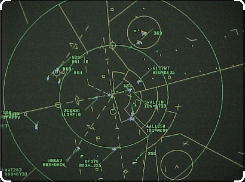 ATC controller view of radar scope showing aircraft on a PAR final, with controller call-outs